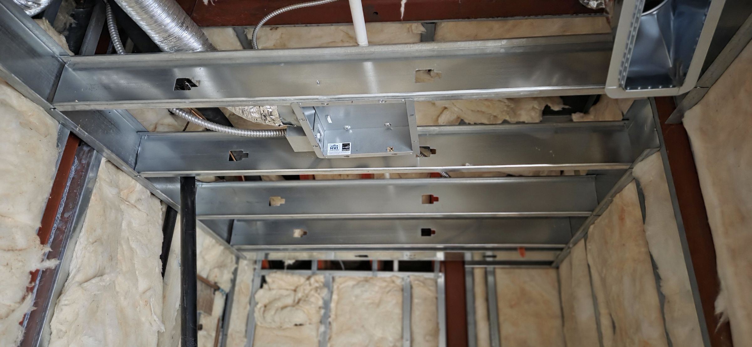 Light-gauge steel ceiling grid framed around ductwork and services