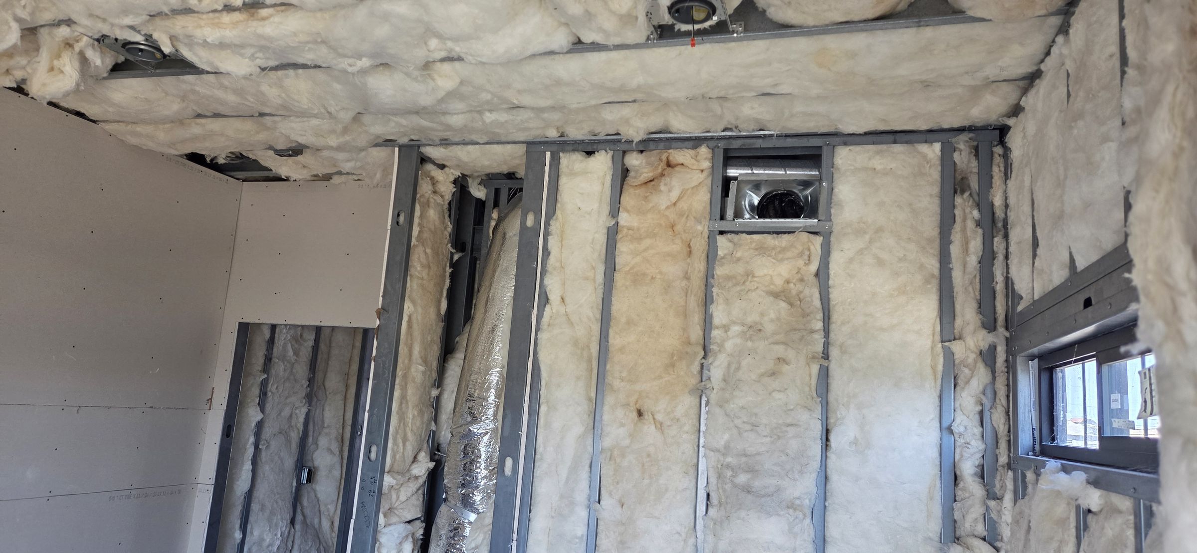 Steel framing and insulation at a window return on a San Diego job