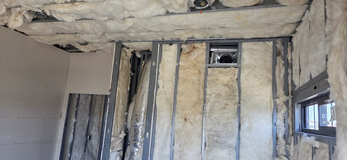 Framing and insulation at a window return.