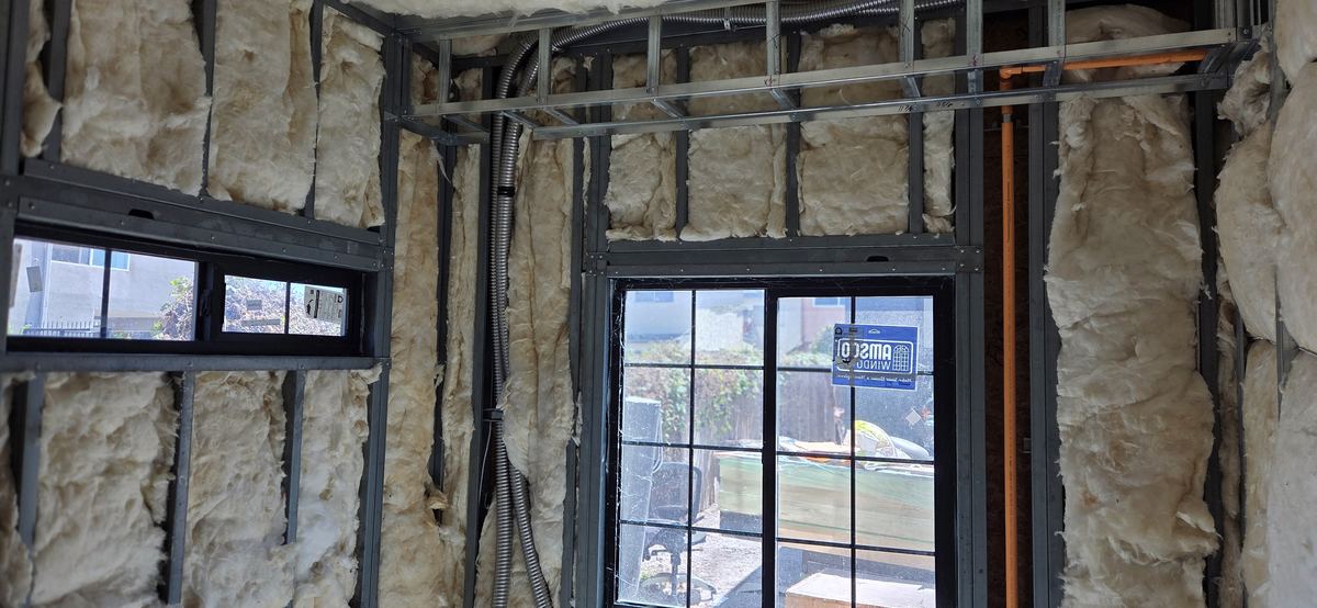 Framing detailed around storefront glazing.