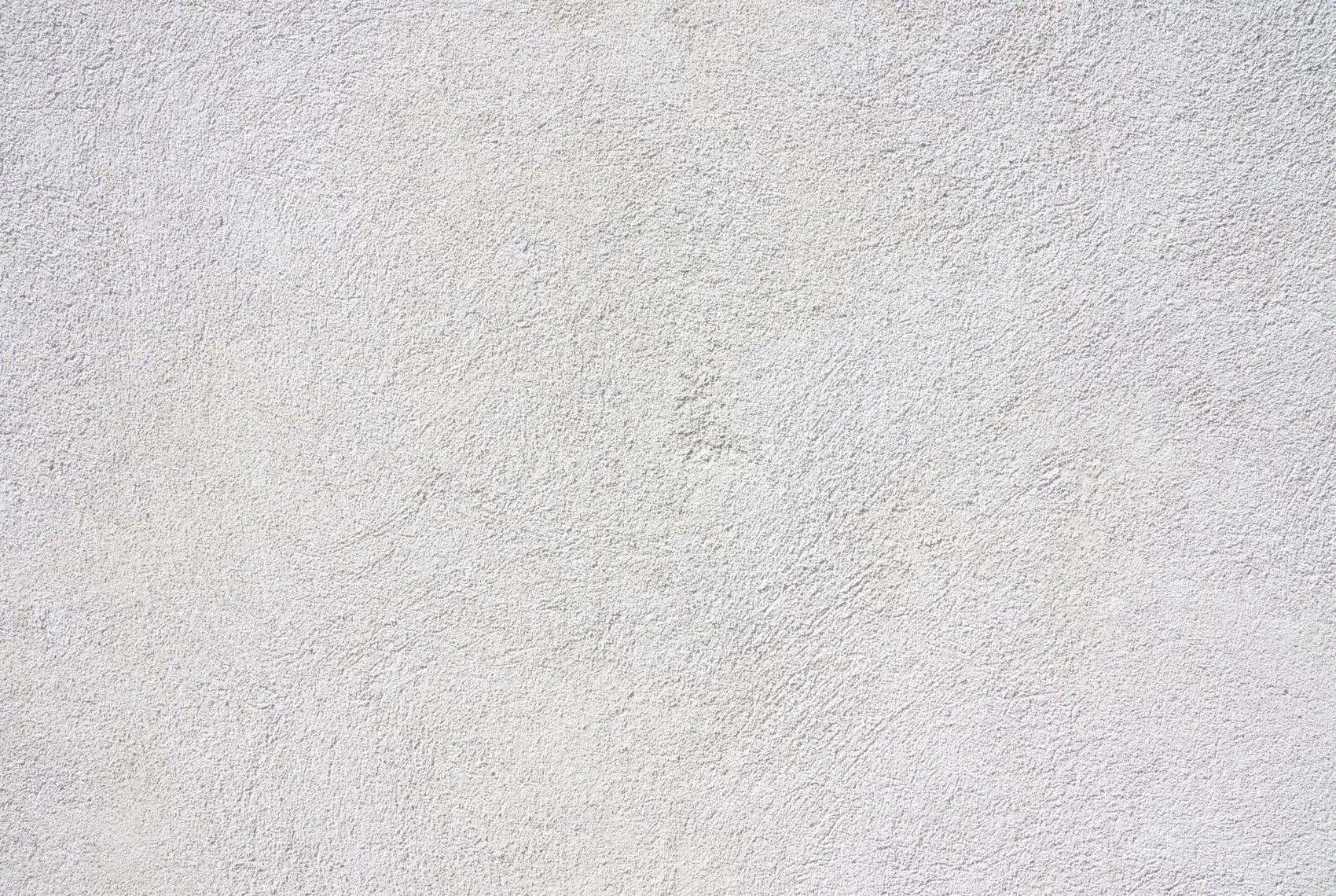Close view of hand-applied knockdown drywall texture, the flattened trowel pattern raking across a finished San Diego wall